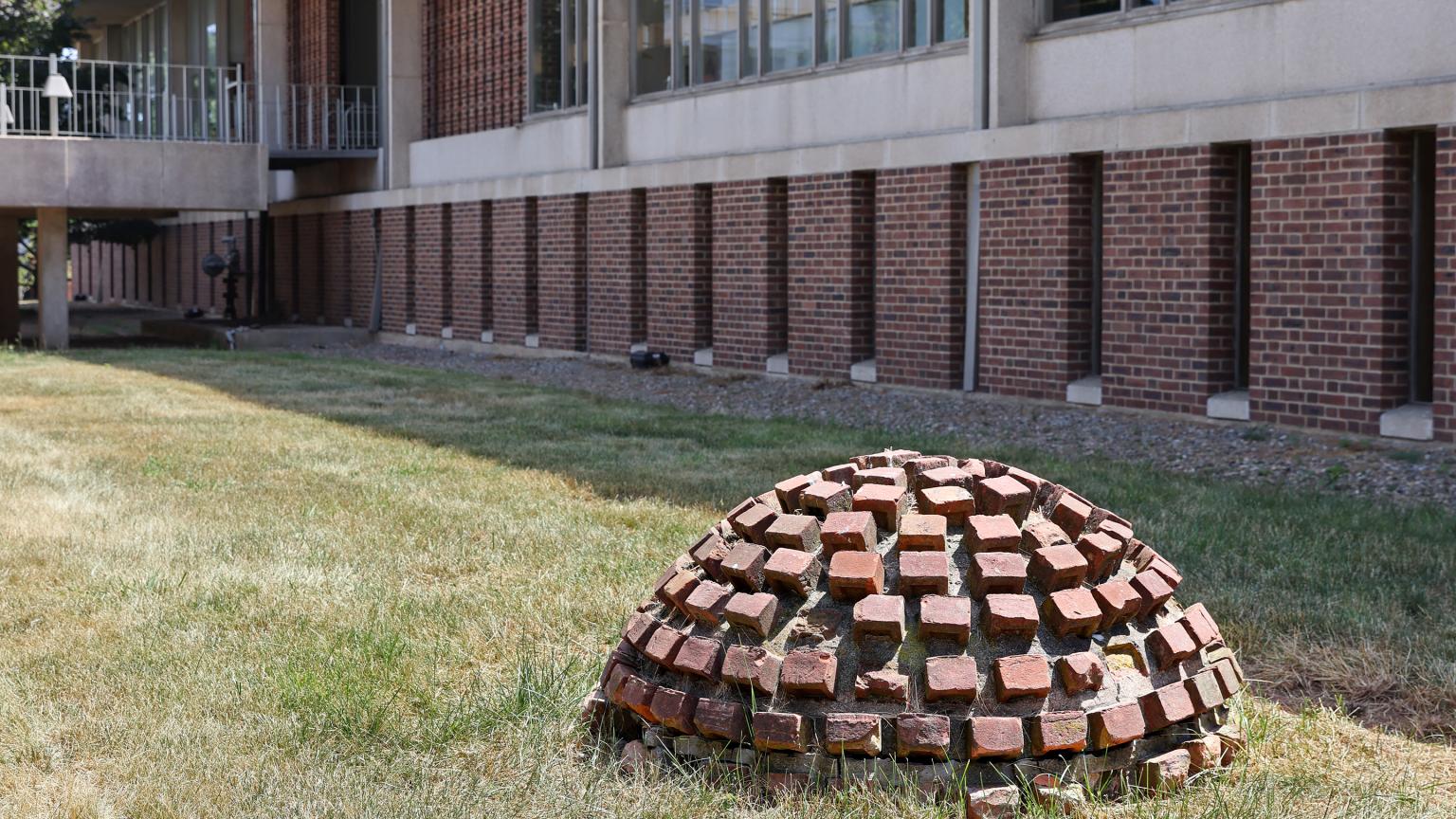 Brick Dome by (Vera) Jackie Winsor located in front of Mabel Smith Douglass Library