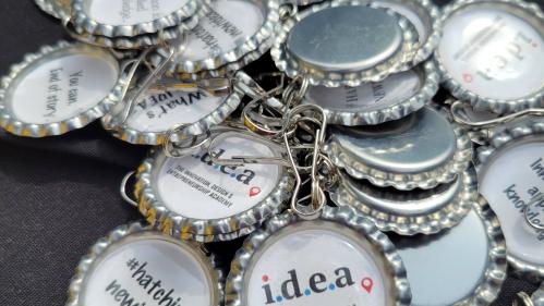 Keychains with innovation slogans: (1) hashtag, hatching new ideas; (2) Innovation is applied knowledge; (3) You can, end of story.