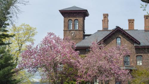 View of College Hall surrounded by emerging cherry blossoms in New Brunswick on the Douglass Campus.