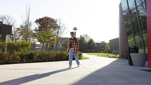 Student walking by Weeks Hall