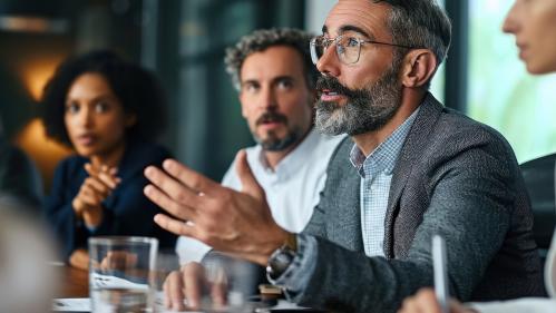 Male in a boardroom speaking to executives