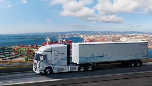 Large tractor trailer races along a highway.
