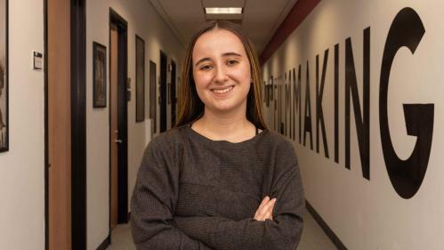 Madeline Hettrick, who wrote and directed the short film “His New Girl,” stands in the hallway outside the Rutgers Filmmaking Center.