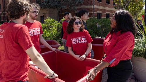 Rutgers-New Brunswick Chancellor Francine Conway (right) speaks with student members of the Residence Life move-in team Monday outside BEST Hall.