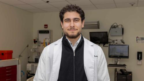 Omar M. Abuattieh stands in a lab room in the Ernest Mario School of Pharmacy.