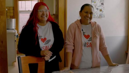 In the documentary "Promotora," Kareli Barragan (left), the daughter of Martha Barragan, stands next to her mother (right) in a kitchen. Both are promotoras.