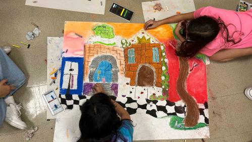 Children color on the floor of the Zimmerli Art Museum during the 2023 Summer Art Camp.