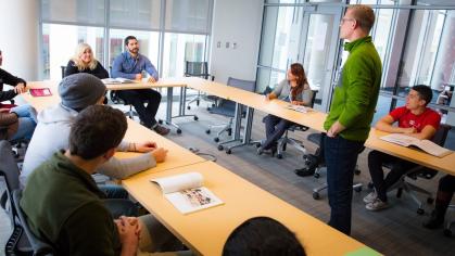 Faculty meet in a conference room.