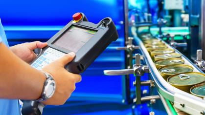 A worker monitors an assembly line