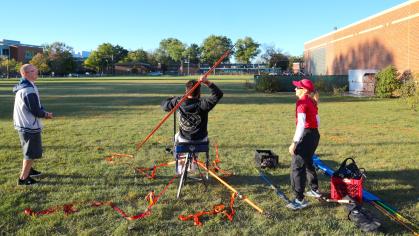 A student athlete throws a javelin