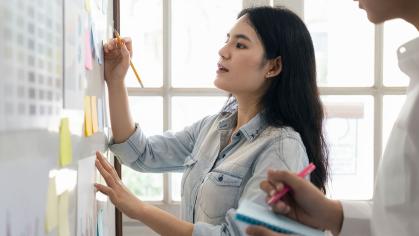 Woman at whiteboard - project management