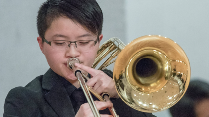 Male student playing trombone