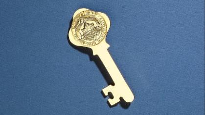 Gold key against blue background