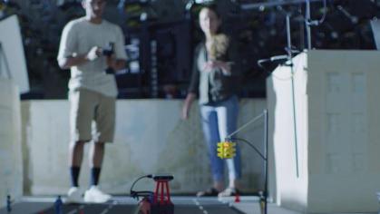 Two students operating robots