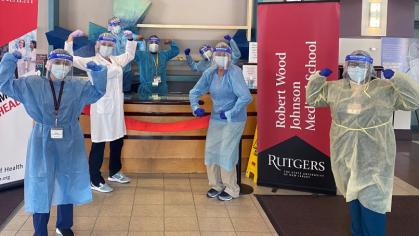 People wearing scrubs, face masks, and gloves