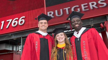 Three student athletes pose for a picture prior to University Commencement