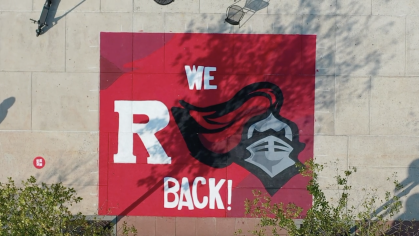 We R Back! painted on sidewalk outside College Avenue Student Center