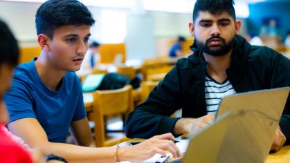 Anvay Patel (SAS '24) and Neel Patel (SAS '24) use their laptops to study in the Busch Learning Center