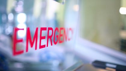 Close-up of the word emergency written on a window in a health care facility
