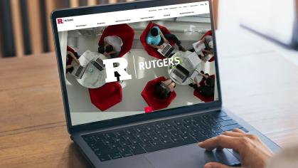 A person types on a laptop at Rutgers