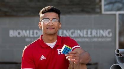 Dylan Sadiq holds a Rubik's cube