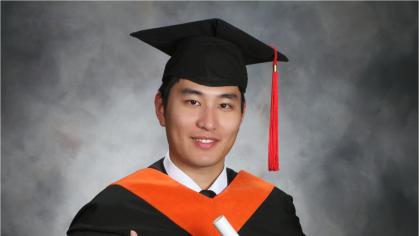 Sichao Wang in a graduation cap and gown