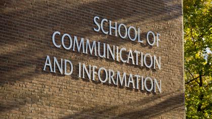 Lettering on the side of a brick building reads "School of Communication and Information"