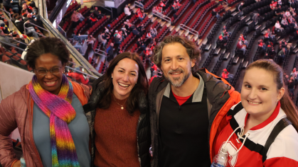 Students attending a New Jersey Devil's game after having met with various managers in the organization on a field trip