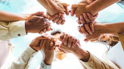 Hands clasped in a circle.