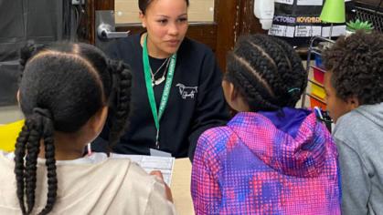 Ashley Ellis talking with a group of students