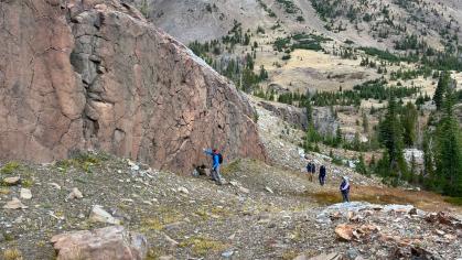 Mountain range with researchers at its base
