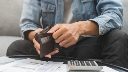 person looking at his wallet