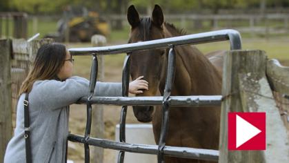 Paula Agustin petting a horse 
