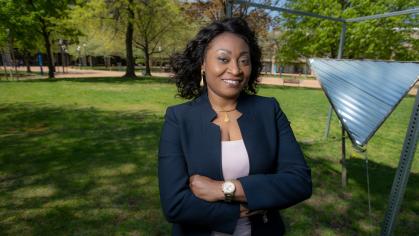 Chinwe Mercy Izegbu standing with her arms folded outside on campus