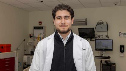 Omar M. Abuattieh stands in a lab room in the Ernest Mario School of Pharmacy.