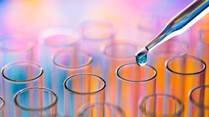 Glass beakers in an array with a pipette