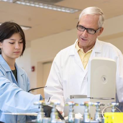 A student and faculty member work in a lab