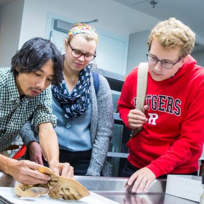 Students watching the inspection of a specimen in a lab setting
