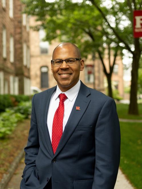 Headshot of Provost Geary in front of a Rutgers building