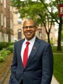 Headshot of Provost Geary in front of a Rutgers building