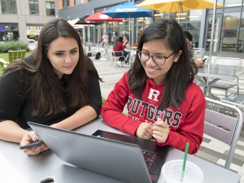 two female students looking at a laptop