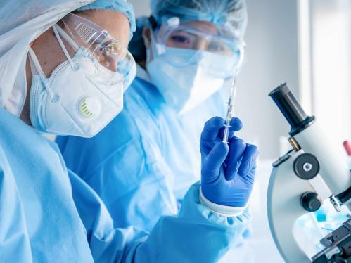 Researchers with vaccine