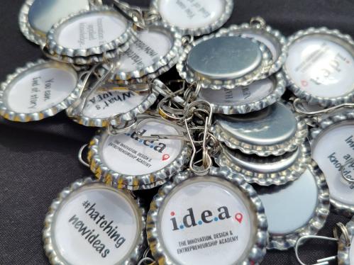 Keychains with innovation slogans: (1) hashtag, hatching new ideas; (2) Innovation is applied knowledge; (3) You can, end of story.