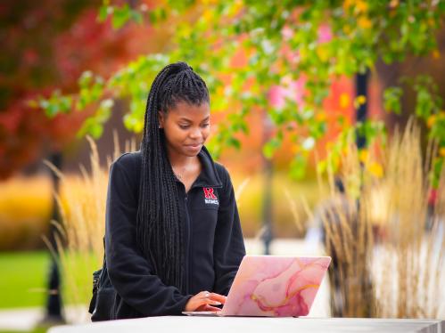 Ryann Sterling (RBS '25) uses her laptop to study on Livingston campus