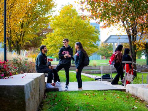 A trio of Rutgers students talking together in an outdoors setting