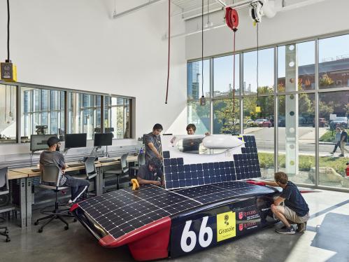 Students building a solar race car at the Rutgers student engineering studio