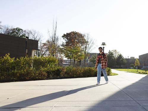 Student walking past Weeks Hall