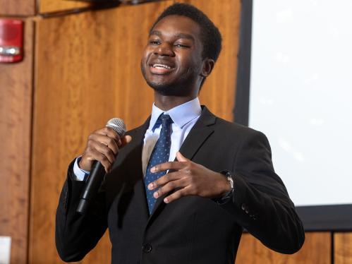 A student speaking with a microphone during a presentation