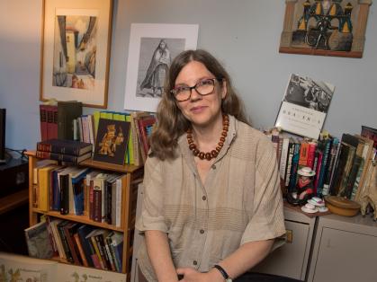 Camilla Townsend sitting on front of bookshelves filled with books