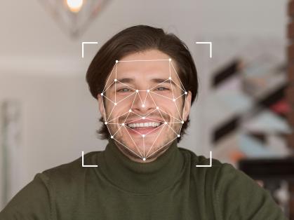 A smiling individual is displayed within a digital facial recognition framework, showcasing advanced identification technology.